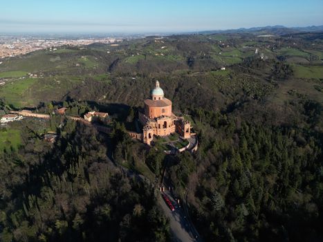 Aerial photograph of the Sanctuary of the Madonna di San Luca in Bologna, surrounded by lush Italian landscapes.