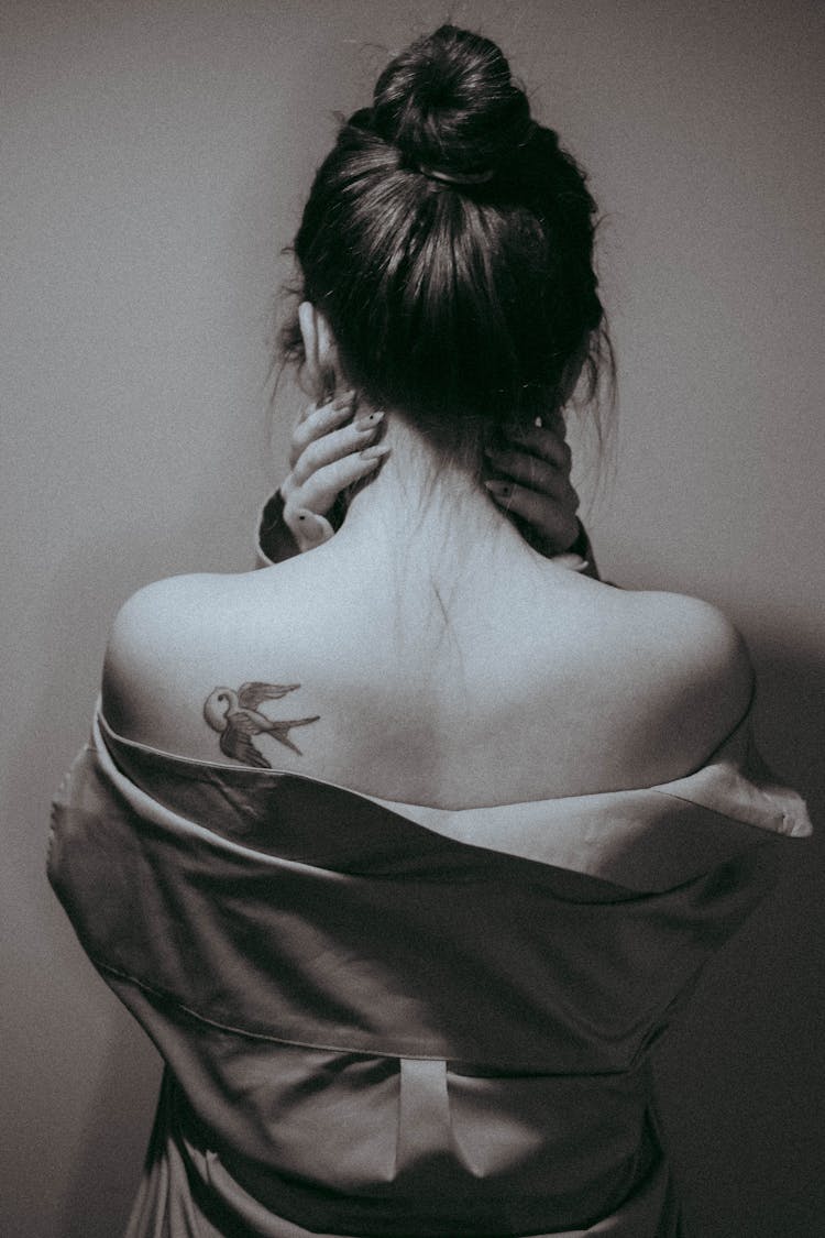 Photo Of A Woman With A Tattoo On Her Arm