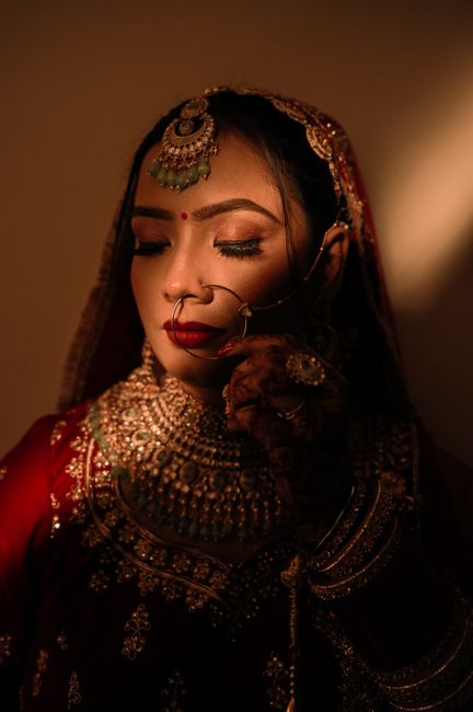 Beautiful portrait of an Indian bride in traditional attire with intricate jewelry.