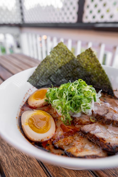 A bowl of ramen with meat and eggs