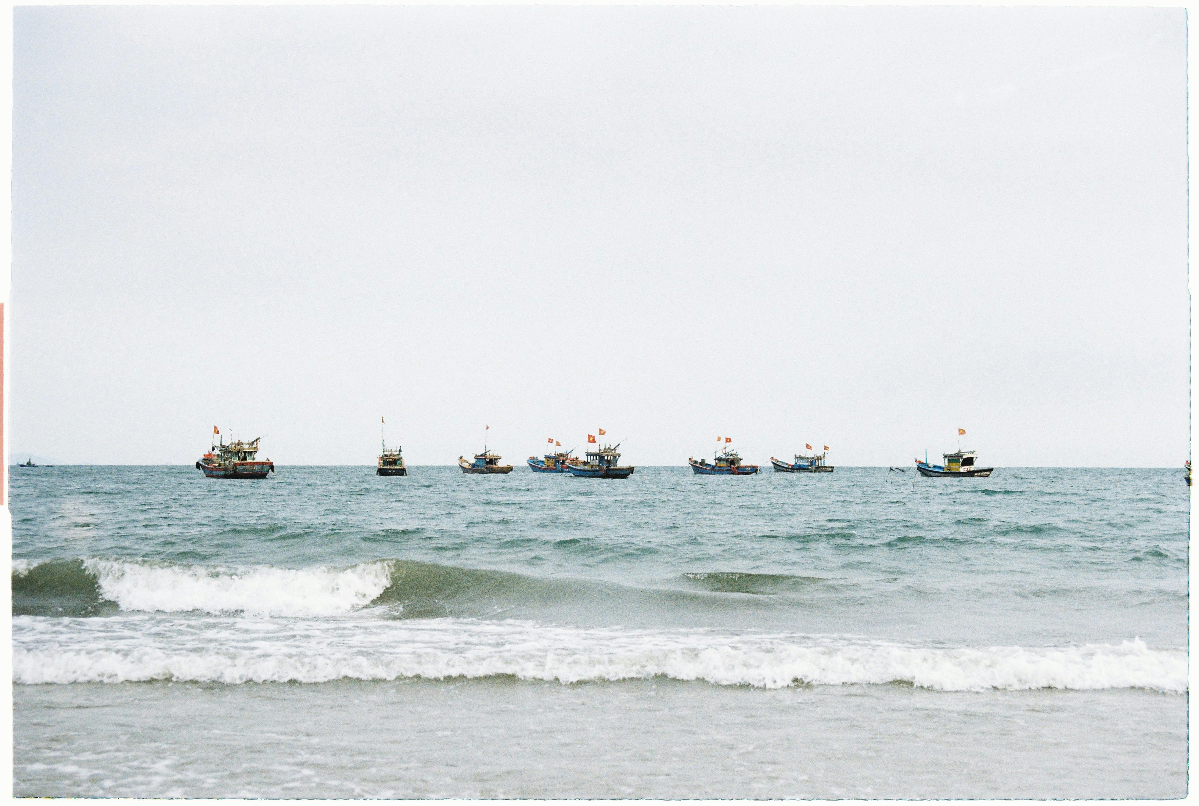 Serene view of fishing boats on the sea from Da Nang, Vietnam coastline.