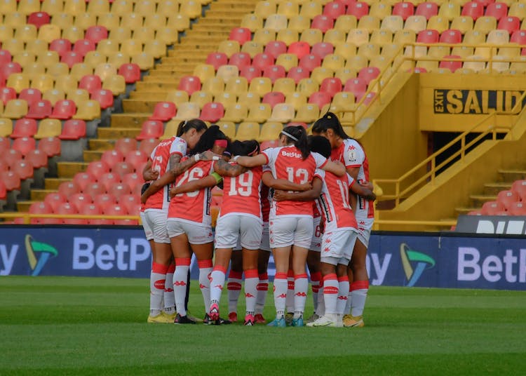 Embracing Women Soccer Team On Stadium 