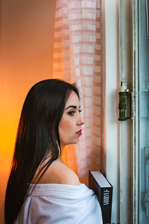 Woman Looking through a Window