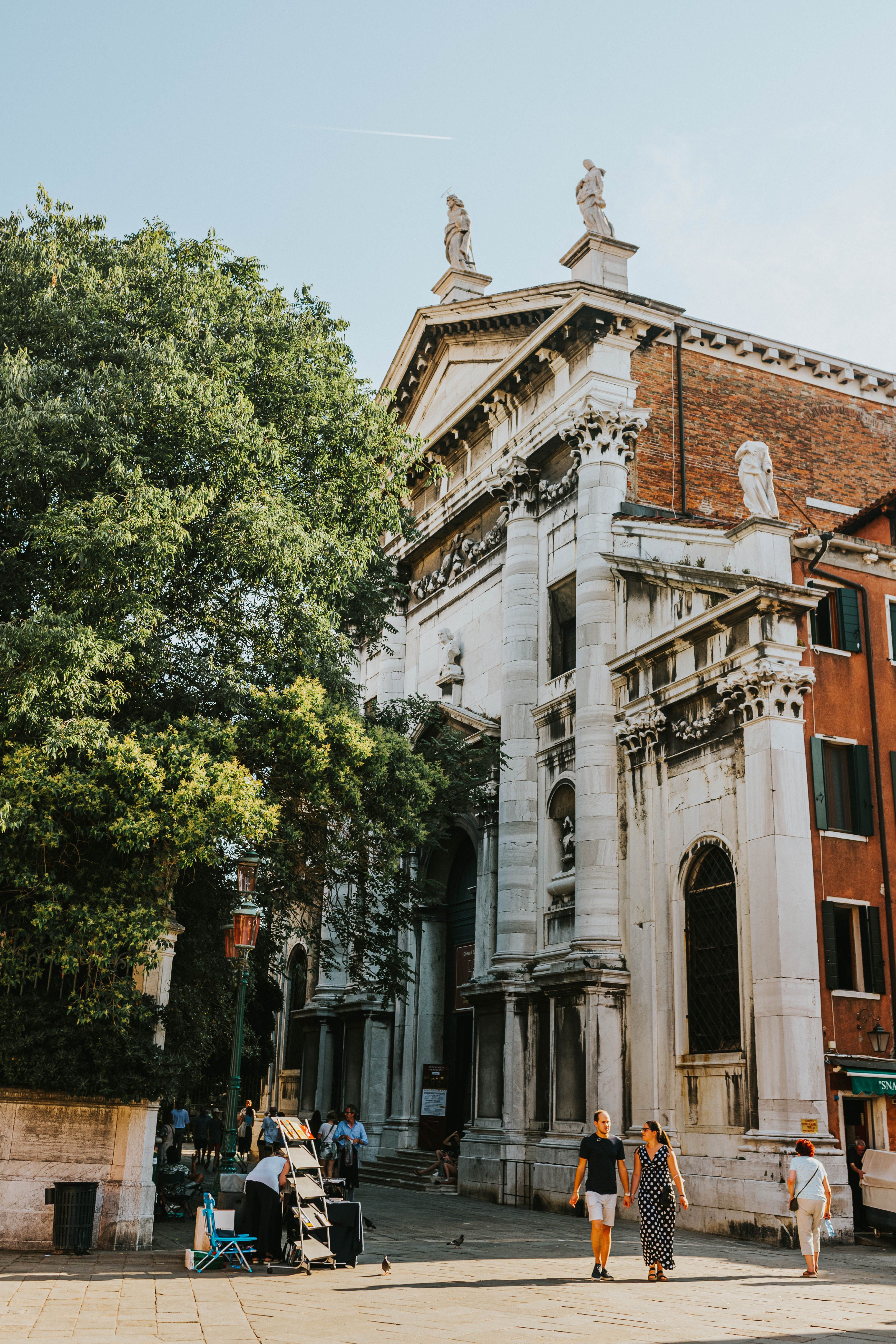 San Vidal Church facade with urban surroundings in Venice, Italy, on a sunny day.