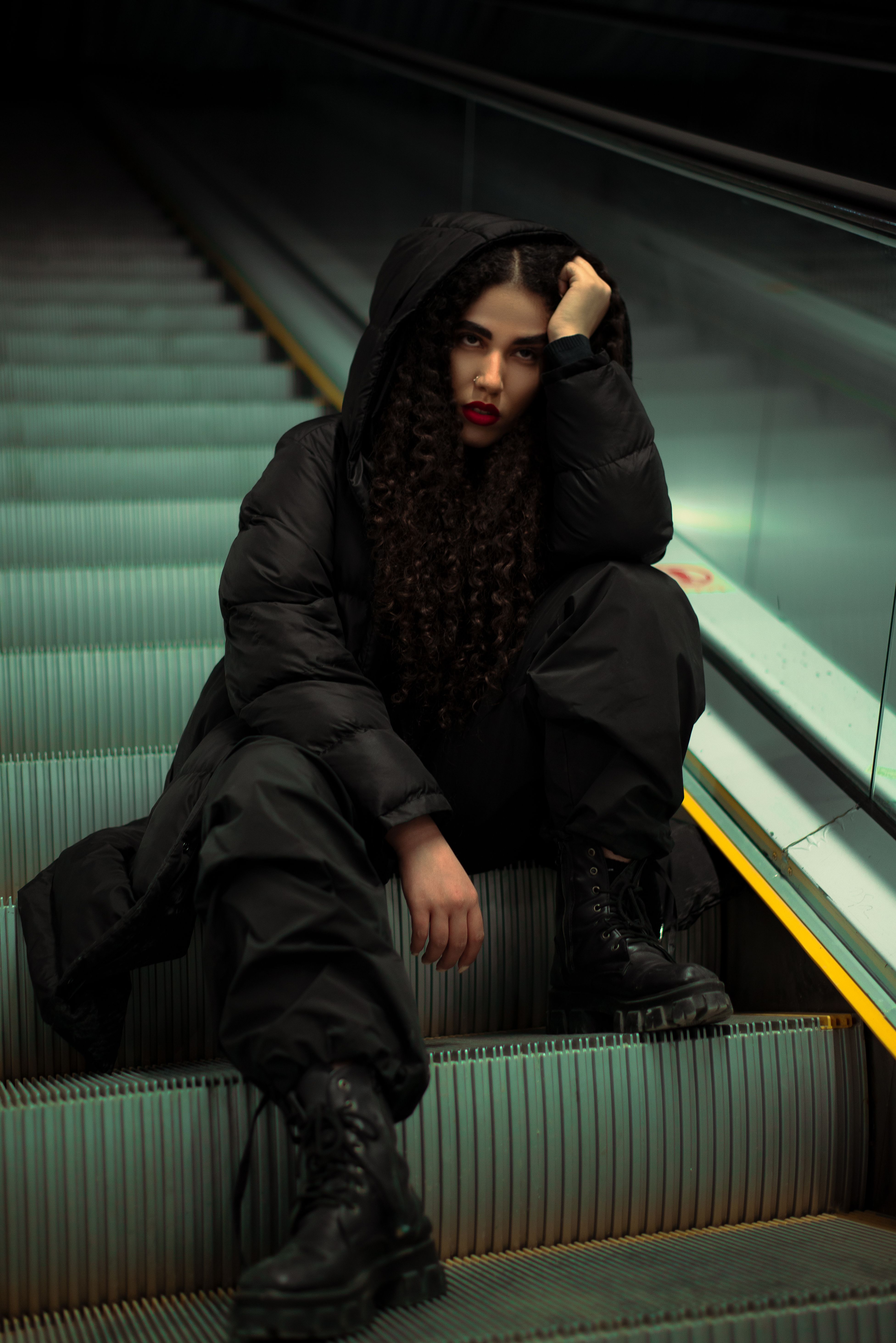 Woman in Black Jacket Sitting on Stairs · Free Stock Photo