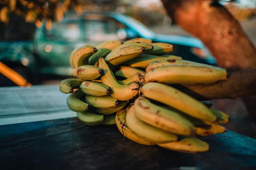 Close-up of a fresh bunch of bananas outdoors with a blurred background.