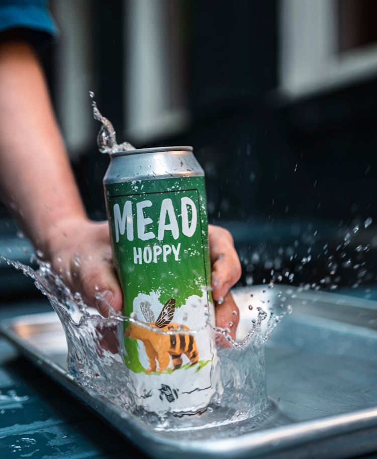 Man Holding A Can Of Craft Beer And Placing It In Water