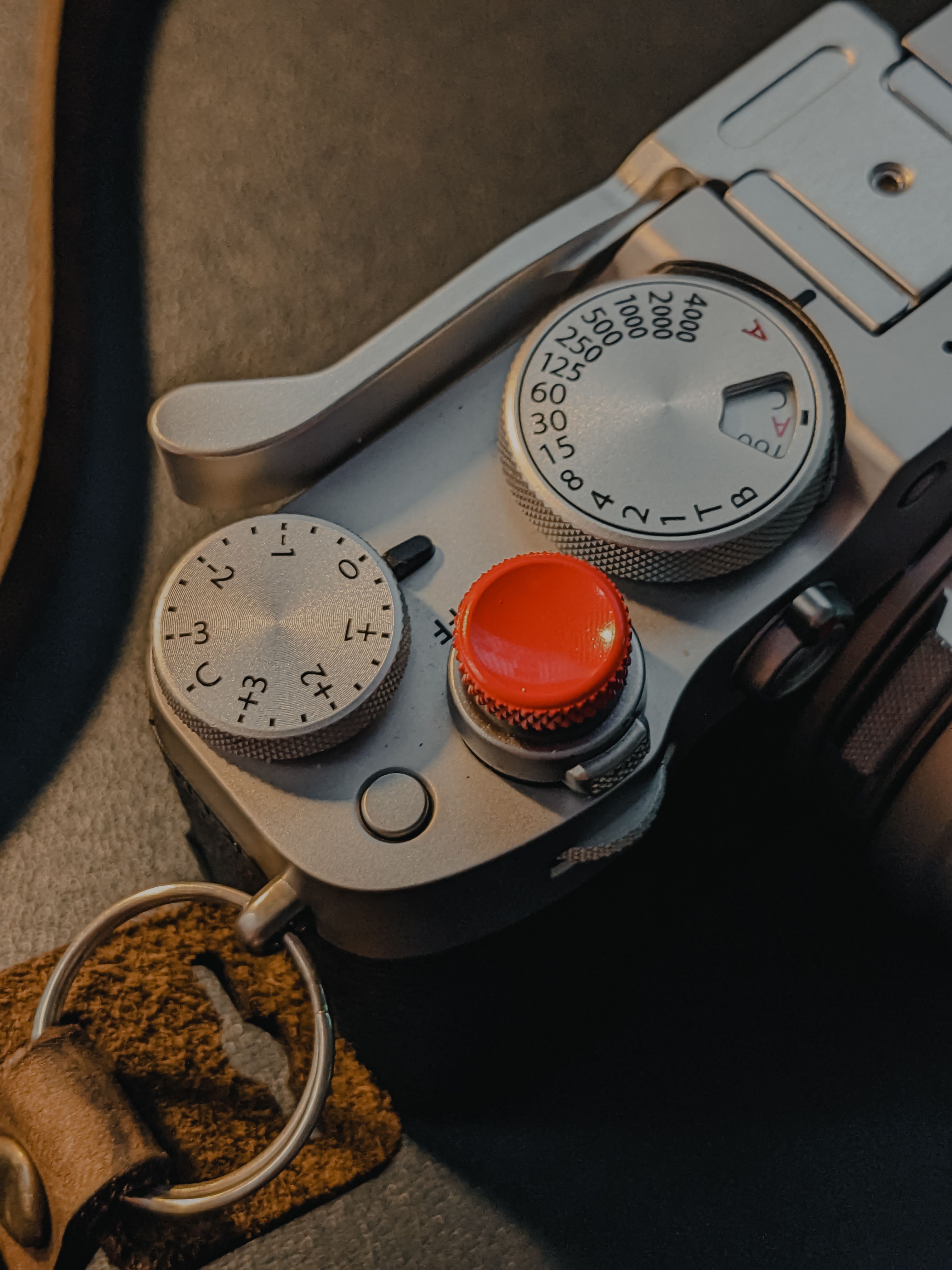 Close view of compact camera controls: mode buttons, flash, and indicators.