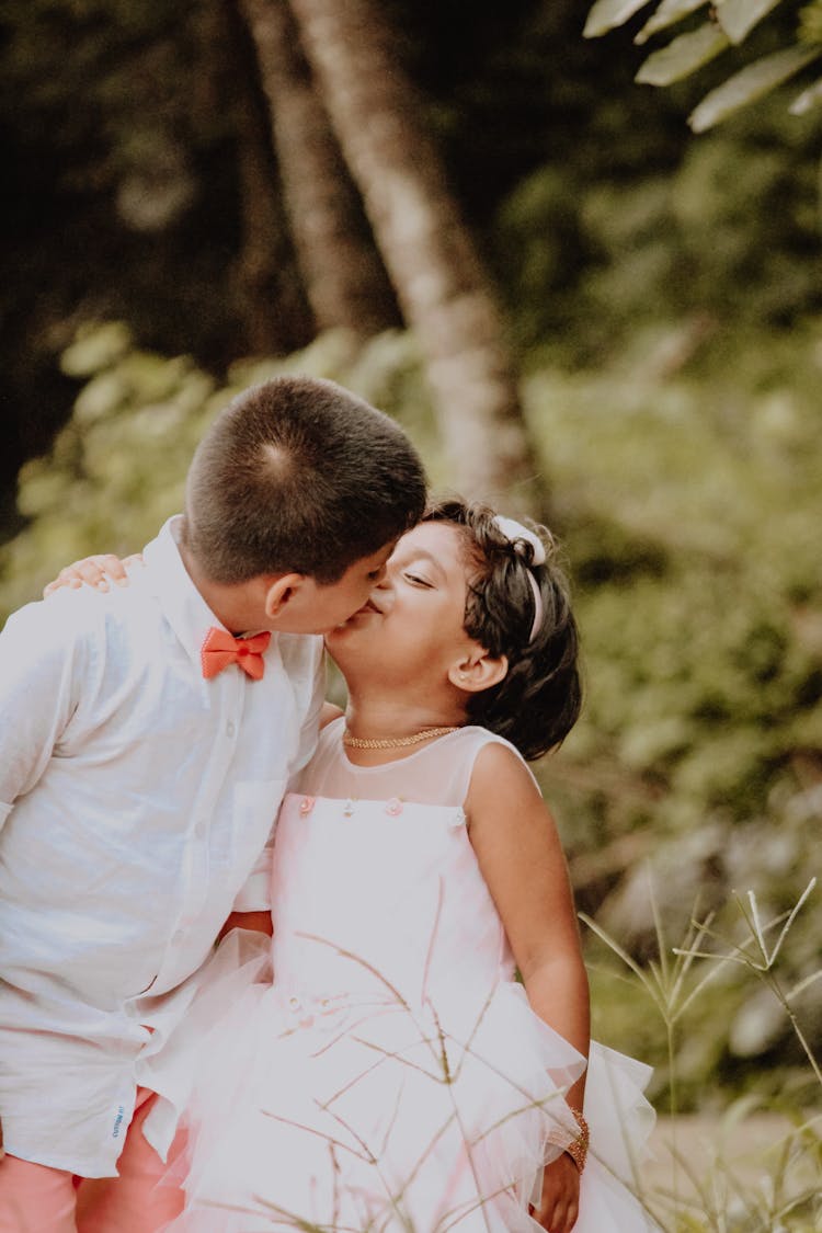 Children Kissing Outdoors 