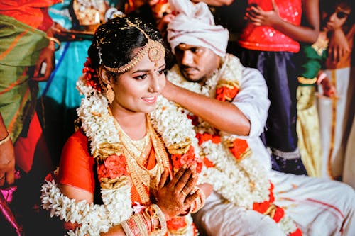 Groom Sitting by Bride in Traditional Dress at Wedding Ceremony