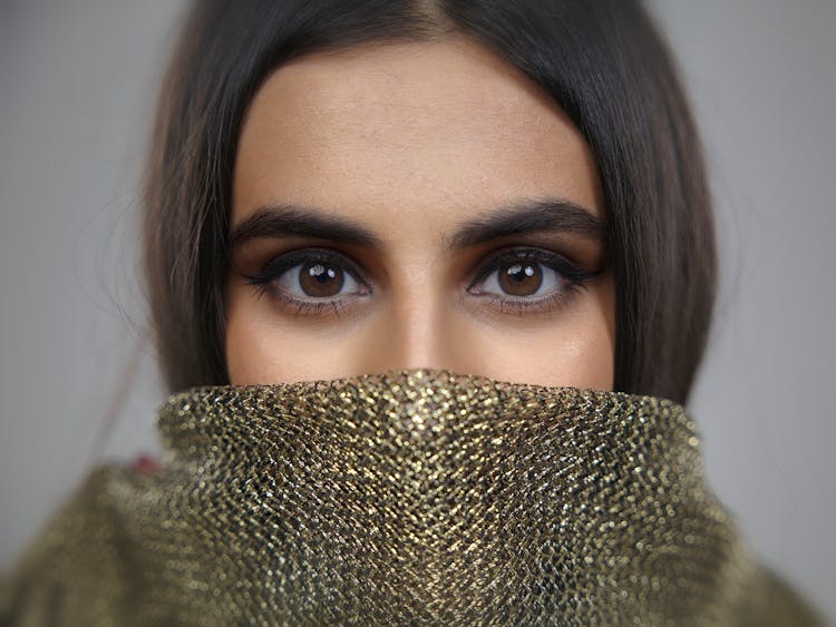 A Portrait Of A Brown Eye Woman In Green Scarf