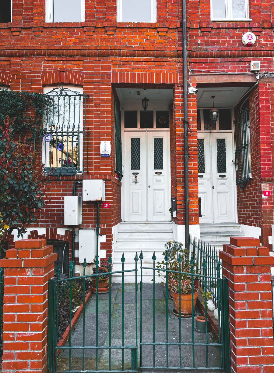 Red brick rowhouse facade typical of Washington, DC residential streets