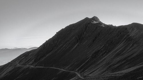 Free An impressive black and white image featuring a mountain peak and a winding road, suggesting adventure. Stock Photo