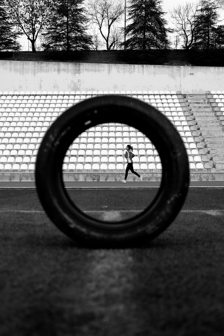 Woman Running On Athletics Stadium