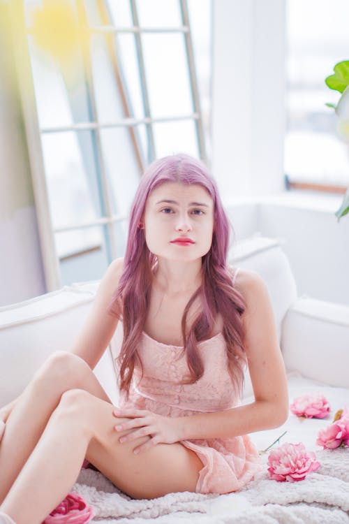 Woman with Dyed Hair Sitting and Posing