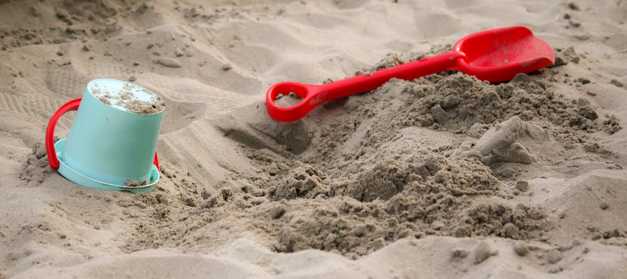 Free Teal Sand Pail Near Sand Shovel Toy Stock Photo
