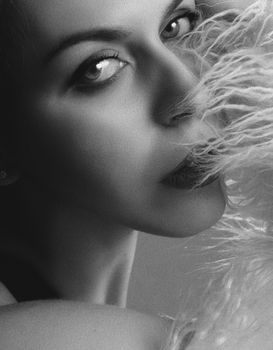Artistic black and white portrait of a woman blending elegance and mystery.