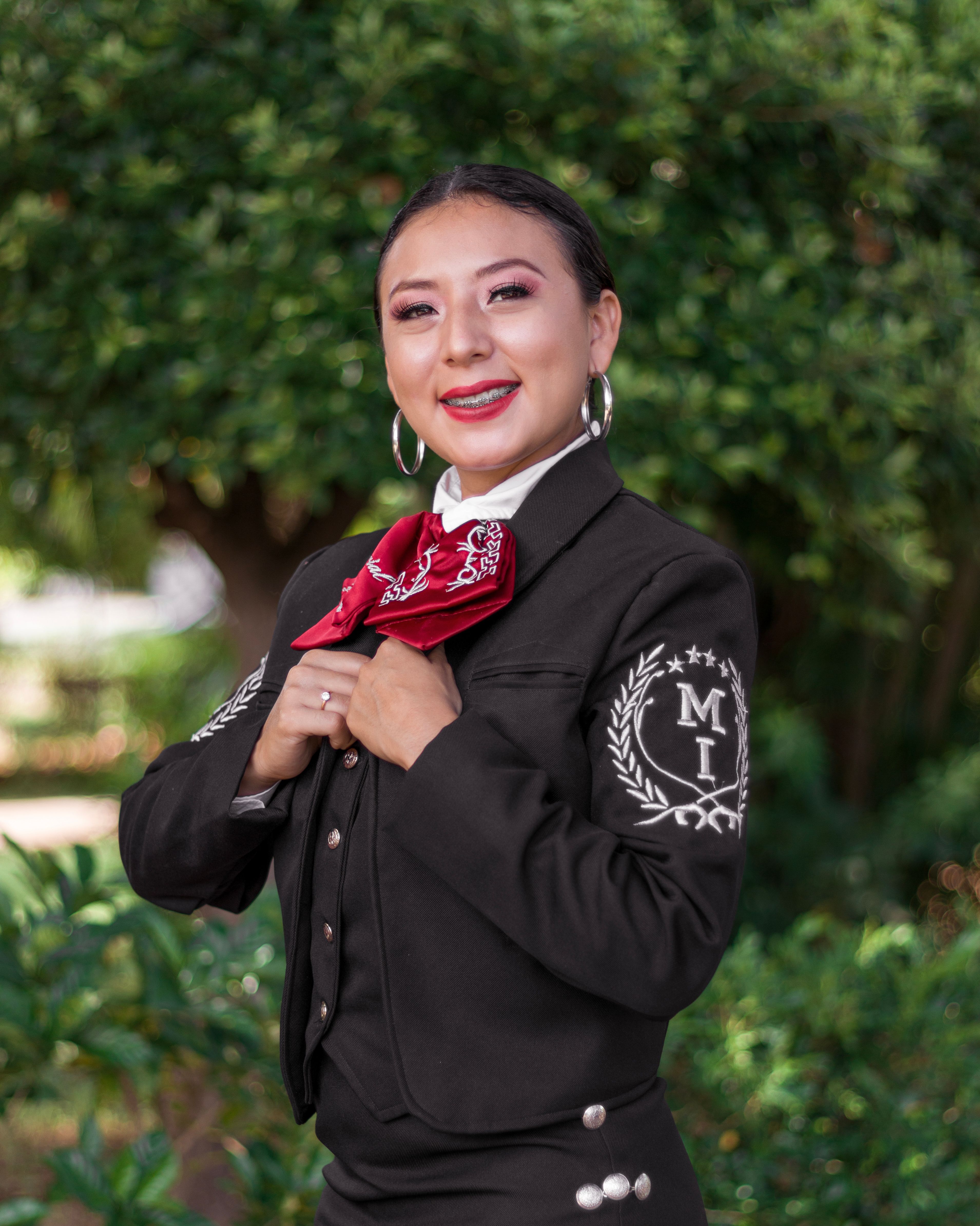 Woman in traditional mariachi attire smiling outdoors in Mérida, Yuc., Mexico.