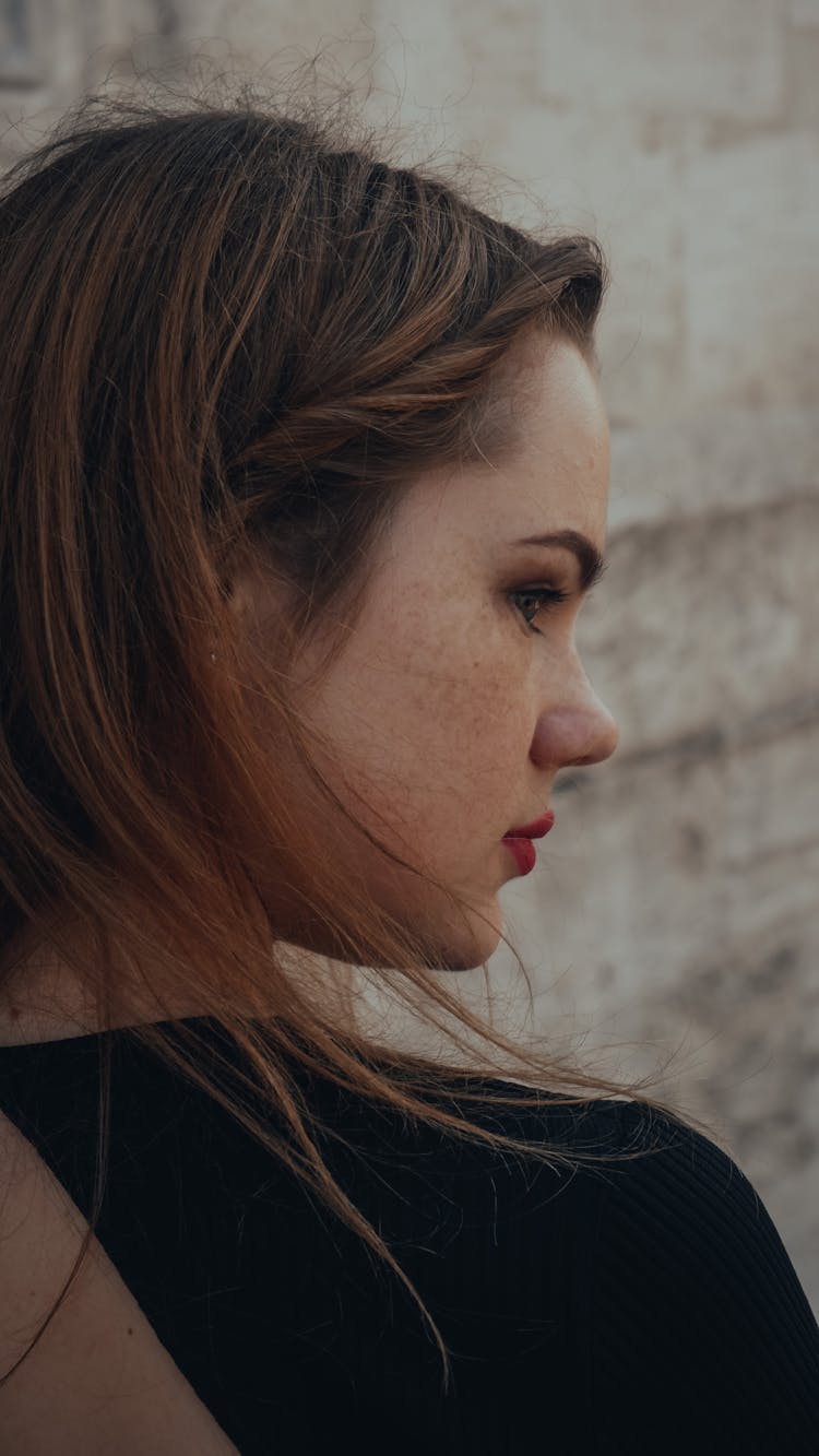 Young Woman Wearing Red Lipstick Looking Over Her Shoulder 