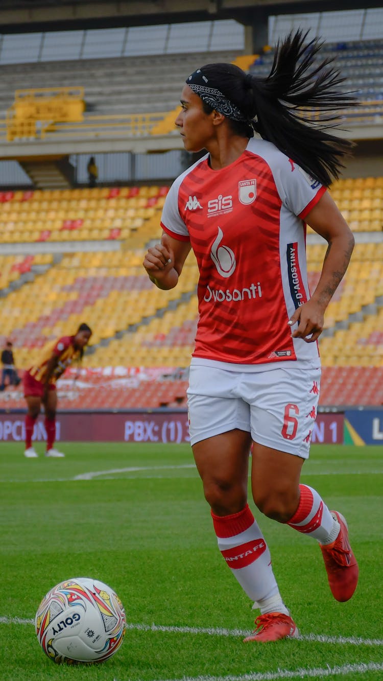 Woman Playing Soccer In A Stadium 