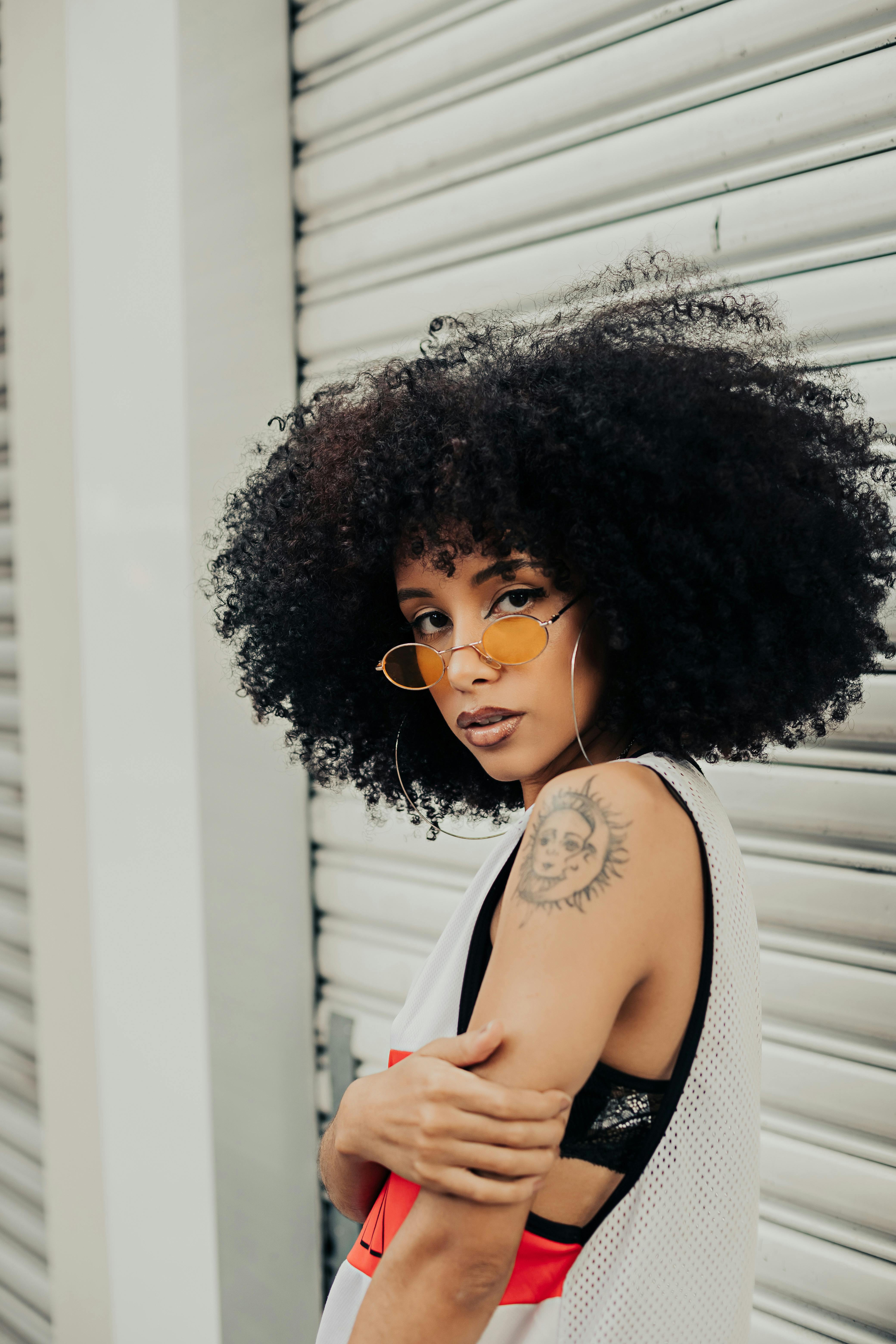 woman with afro and tattoo