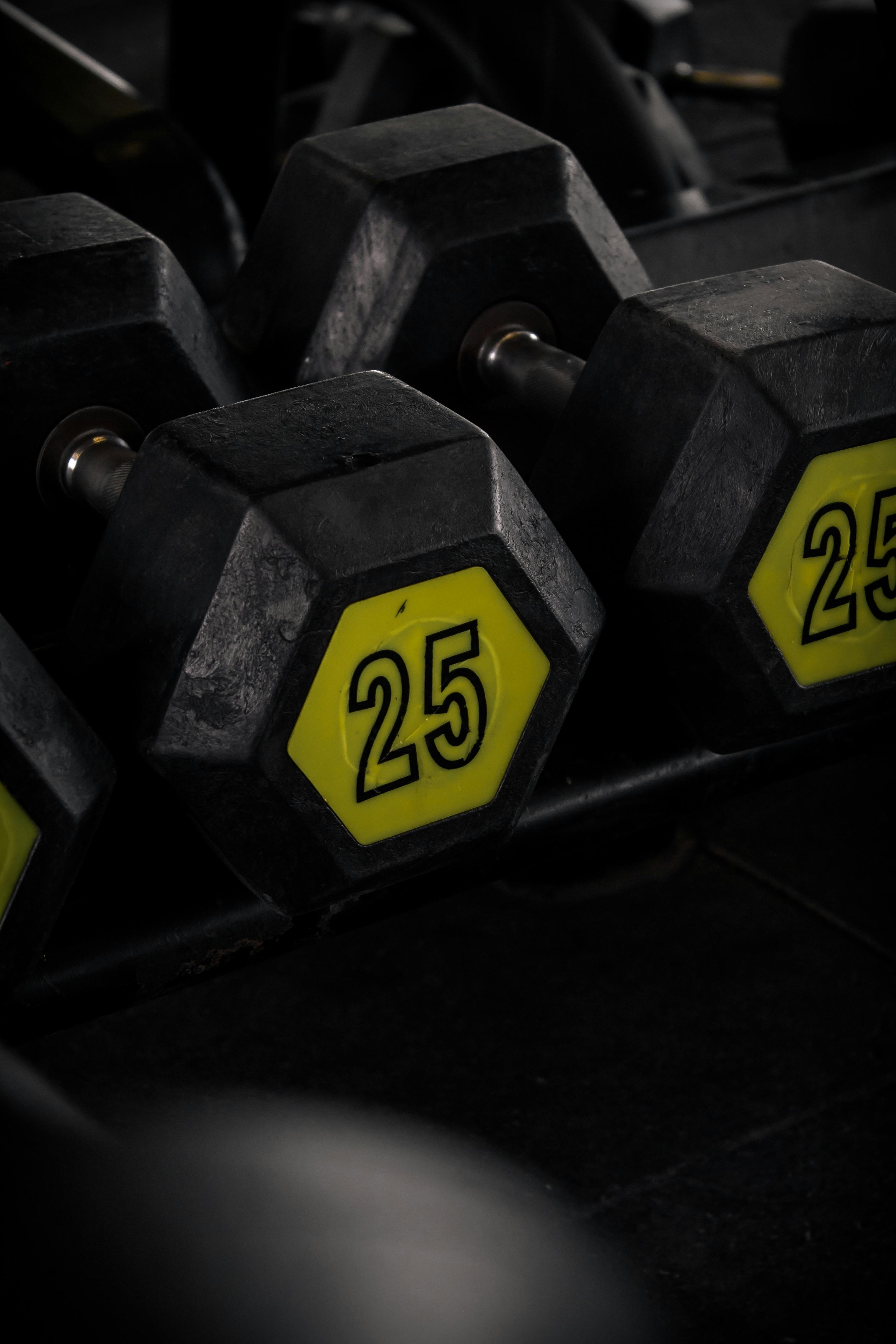 Dumbbells in varying weights, all in sleek black, perfect for versatile  workouts Vertical Mobile Wallpaper AI Generated 31596872 Stock Photo at  Vecteezy