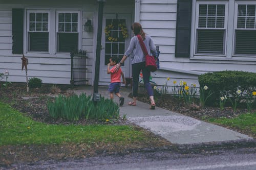Free Woman and Boy in Front of House Stock Photo
