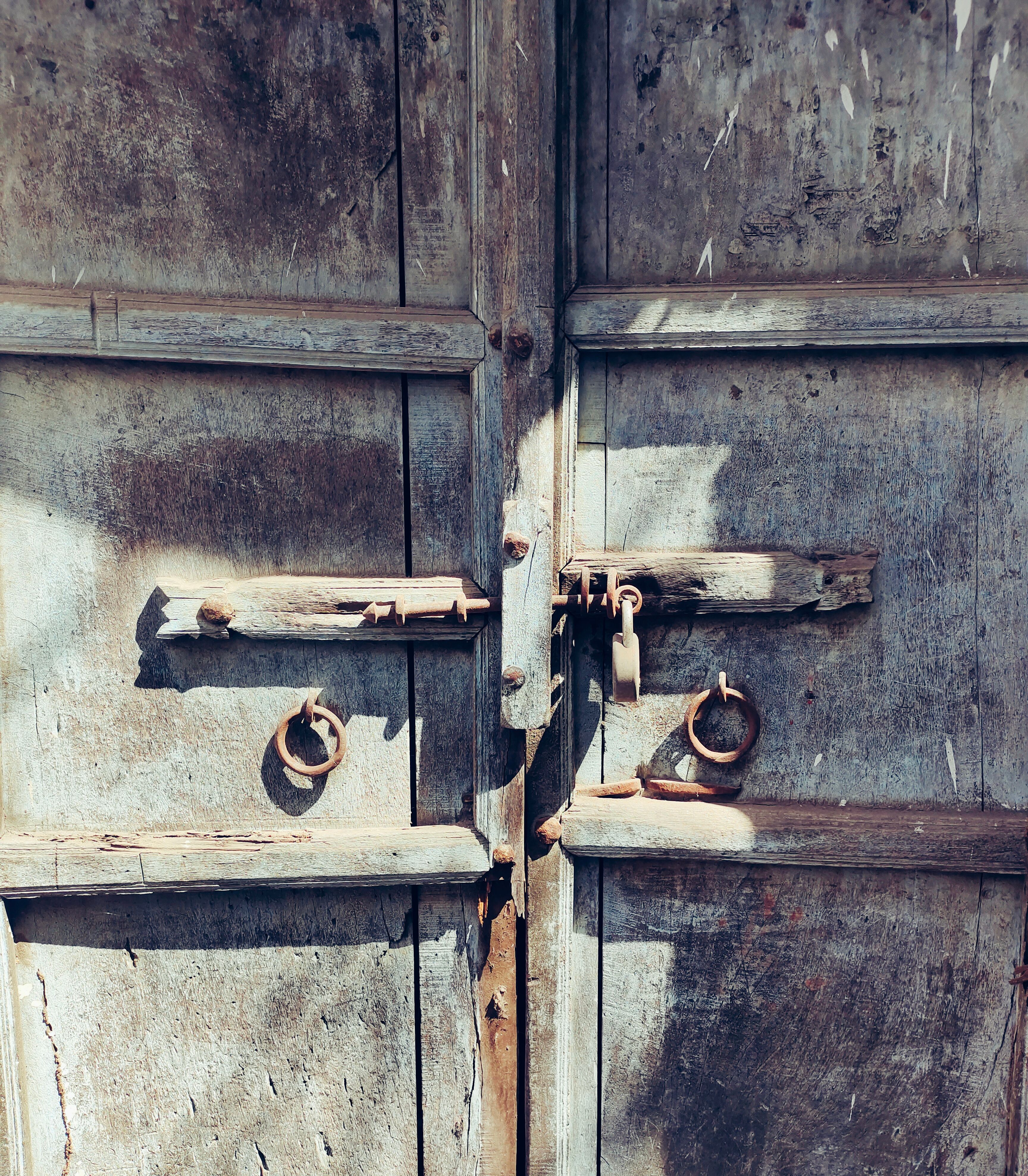 An old wooden door with two locks on it · Free Stock Photo
