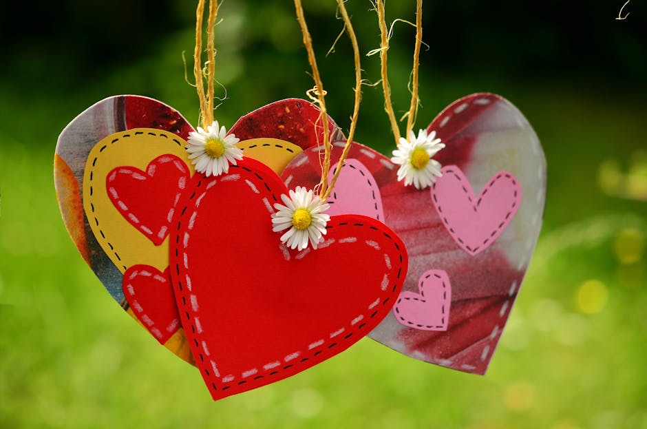 Three Red Hearts Hanging With White Flowers