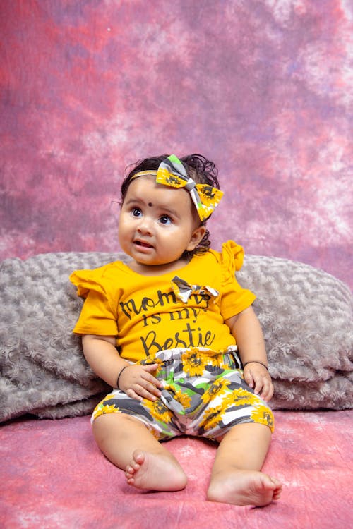 A Little Girl Sitting on the Bed