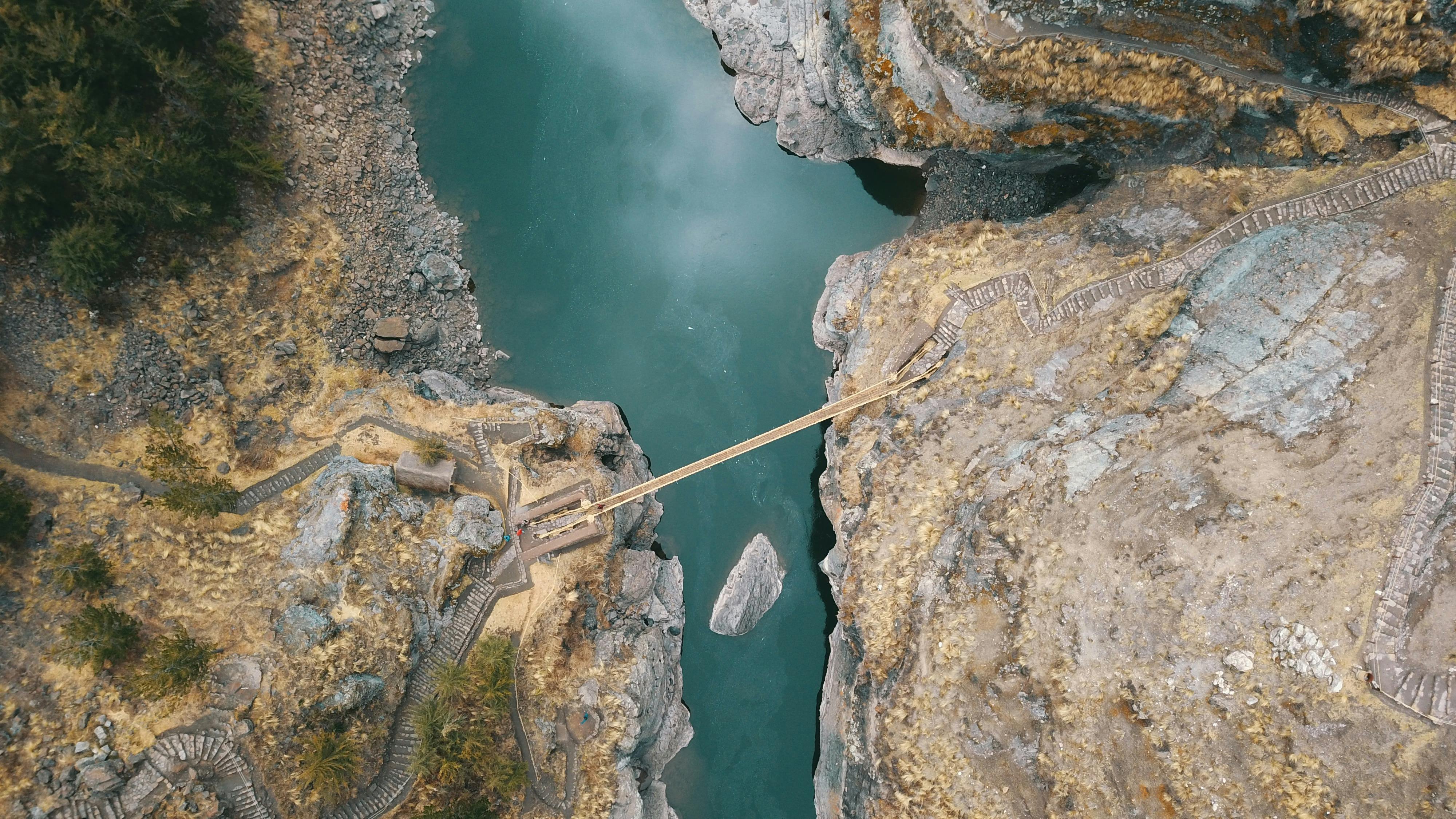 aerial photography of cliff with bridge