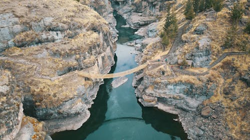 Aerial Photography of Brown Hanging Bridge Connecting Two Cliffs
