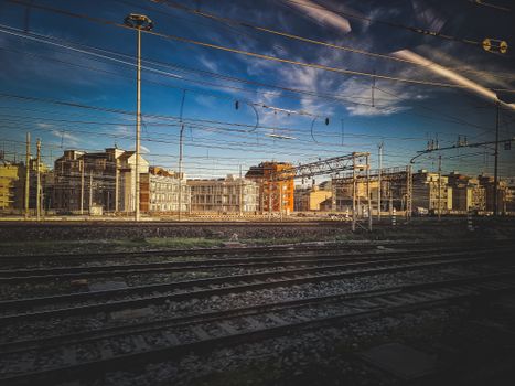 Captivating view of a city's railway tracks amidst architecture under a bright blue sky.
