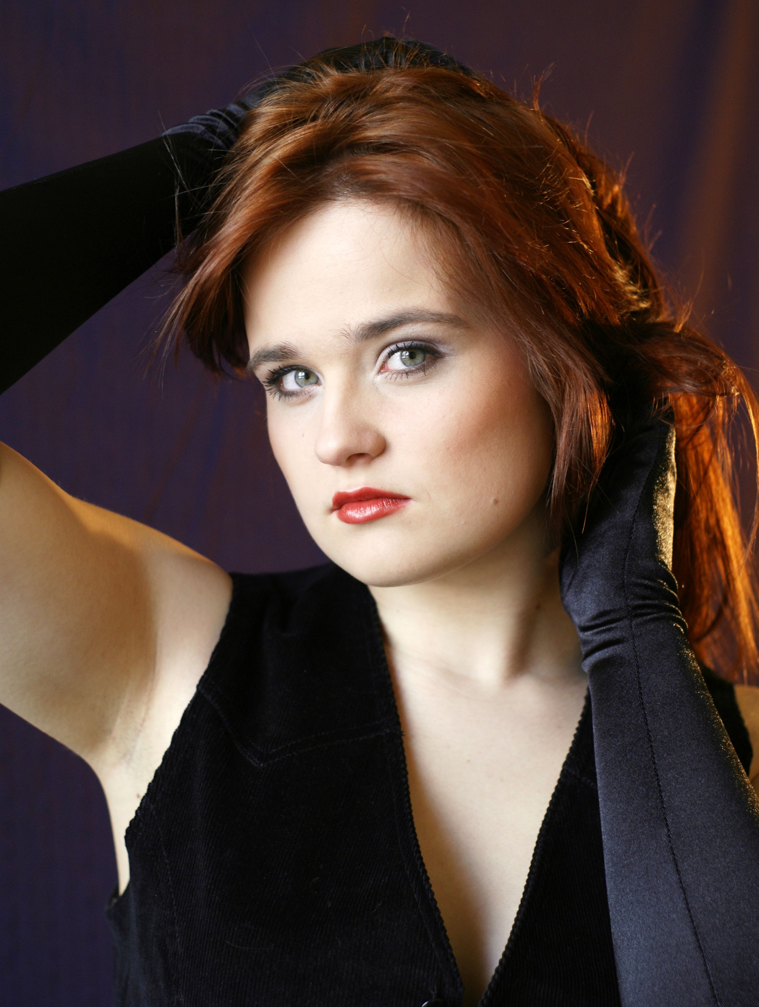 A woman with red hair and black gloves posing · Free Stock Photo