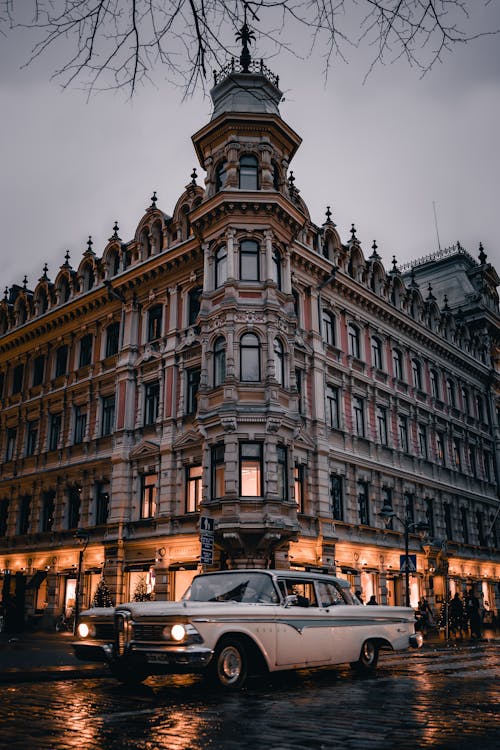 Old Car Driving by Gronqvist House in Helsinki, Finland