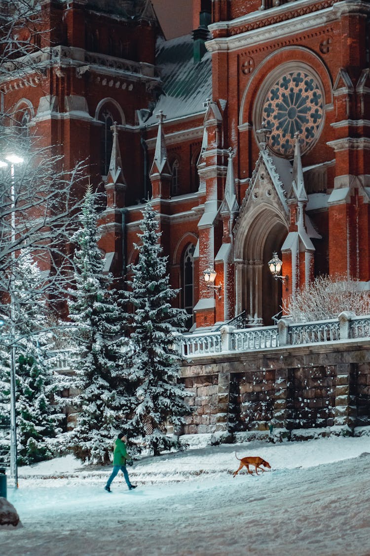 Person Walking With Dog By St. Johns Church In Helsinki, Finland