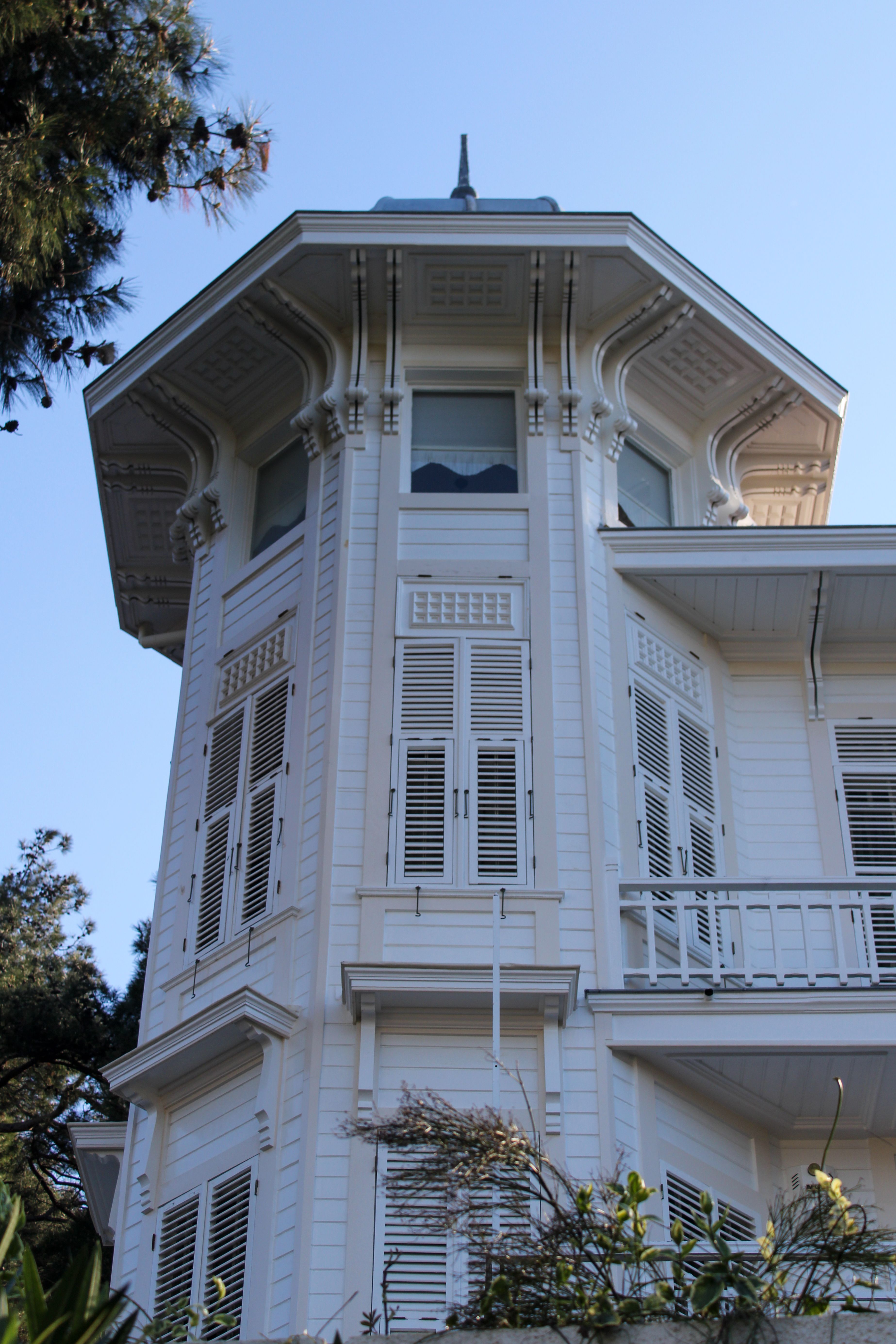 A stunning low-angle view of a historical building in Heybeliada, highlighting Ottoman architectural details.