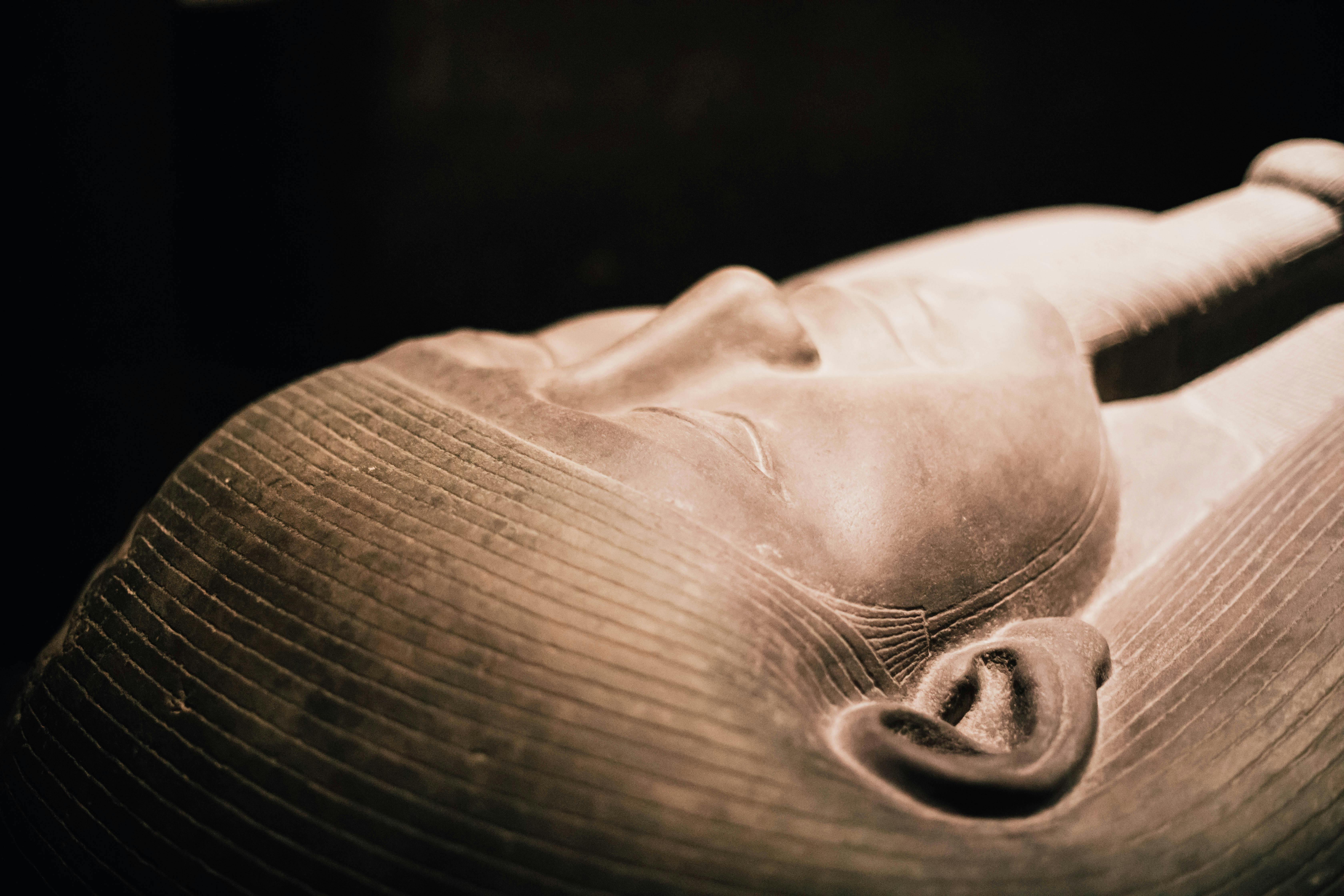 Detailed close-up of an ancient Egyptian sarcophagus, showcasing intricate craftsmanship.
