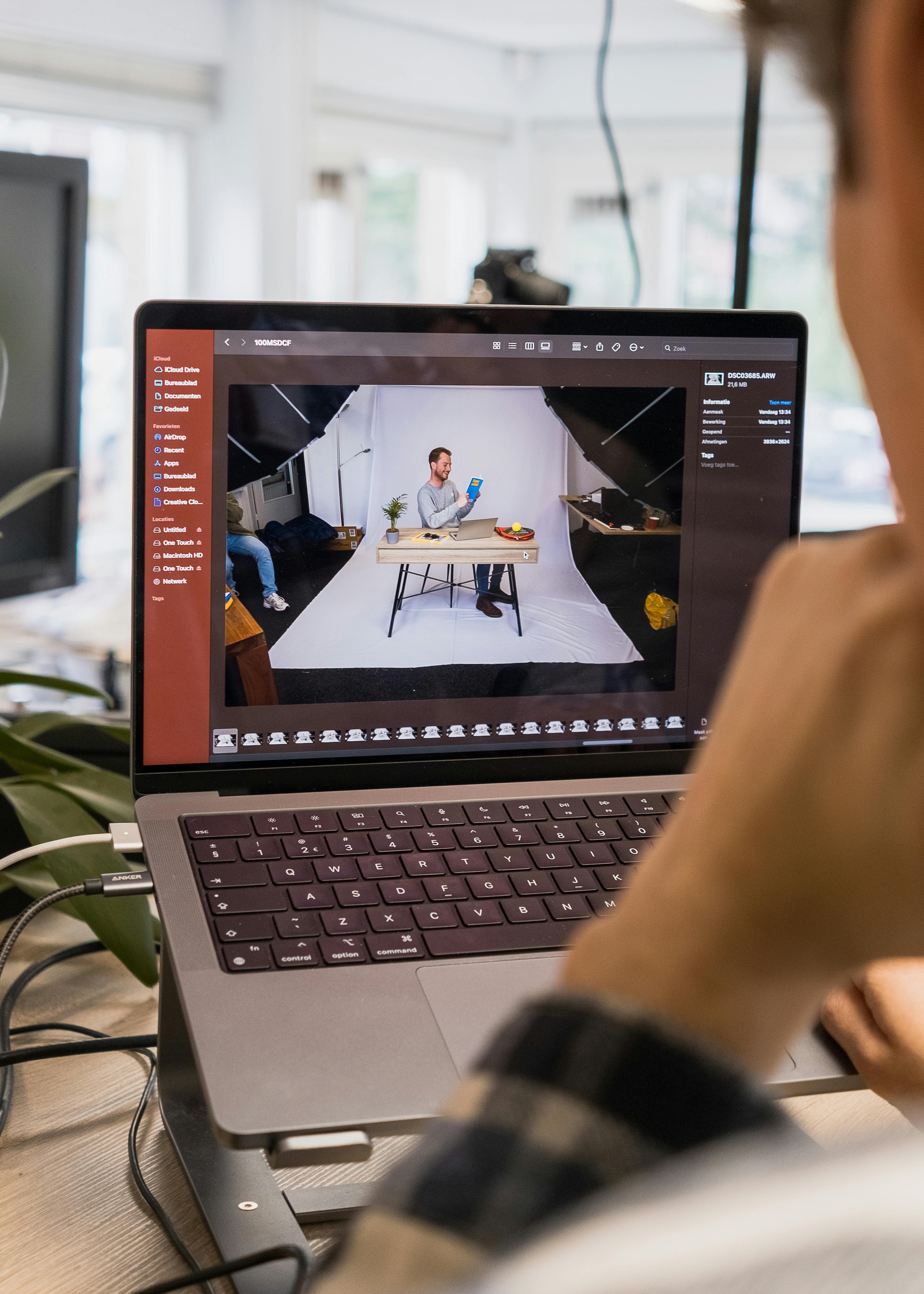 man editing a video on a laptop