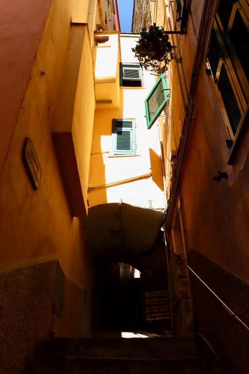 Free Explore a narrow Mediterranean alleyway with stairs leading to sunlit architecture. Stock Photo
