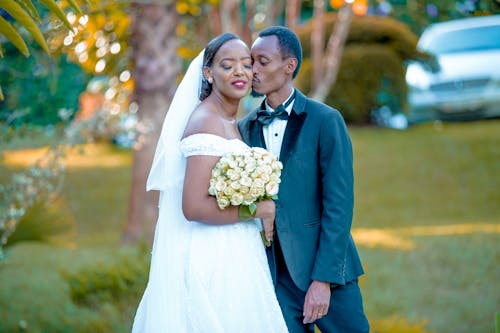 The Groom Kissing the Bride on the Cheek 