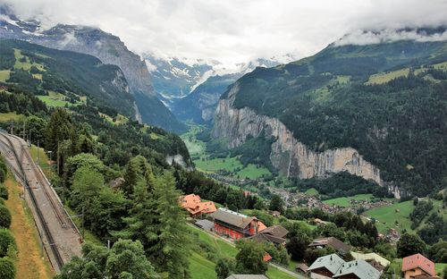 Explore the breathtaking landscape of Lauterbrunnen Valley in Switzerland, featuring lush greenery and majestic mountains.