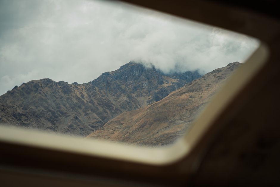 Breathtaking mountain landscape of the Andes visible through a window in Cusco, Peru.