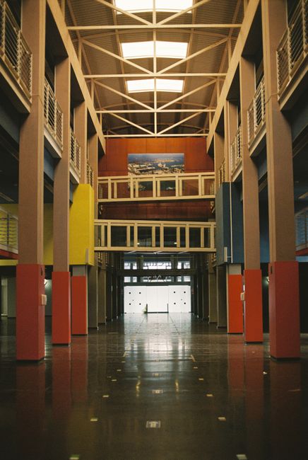 Explore the modern architectural hall in Las Palmas showcasing vibrant columns and symmetry.