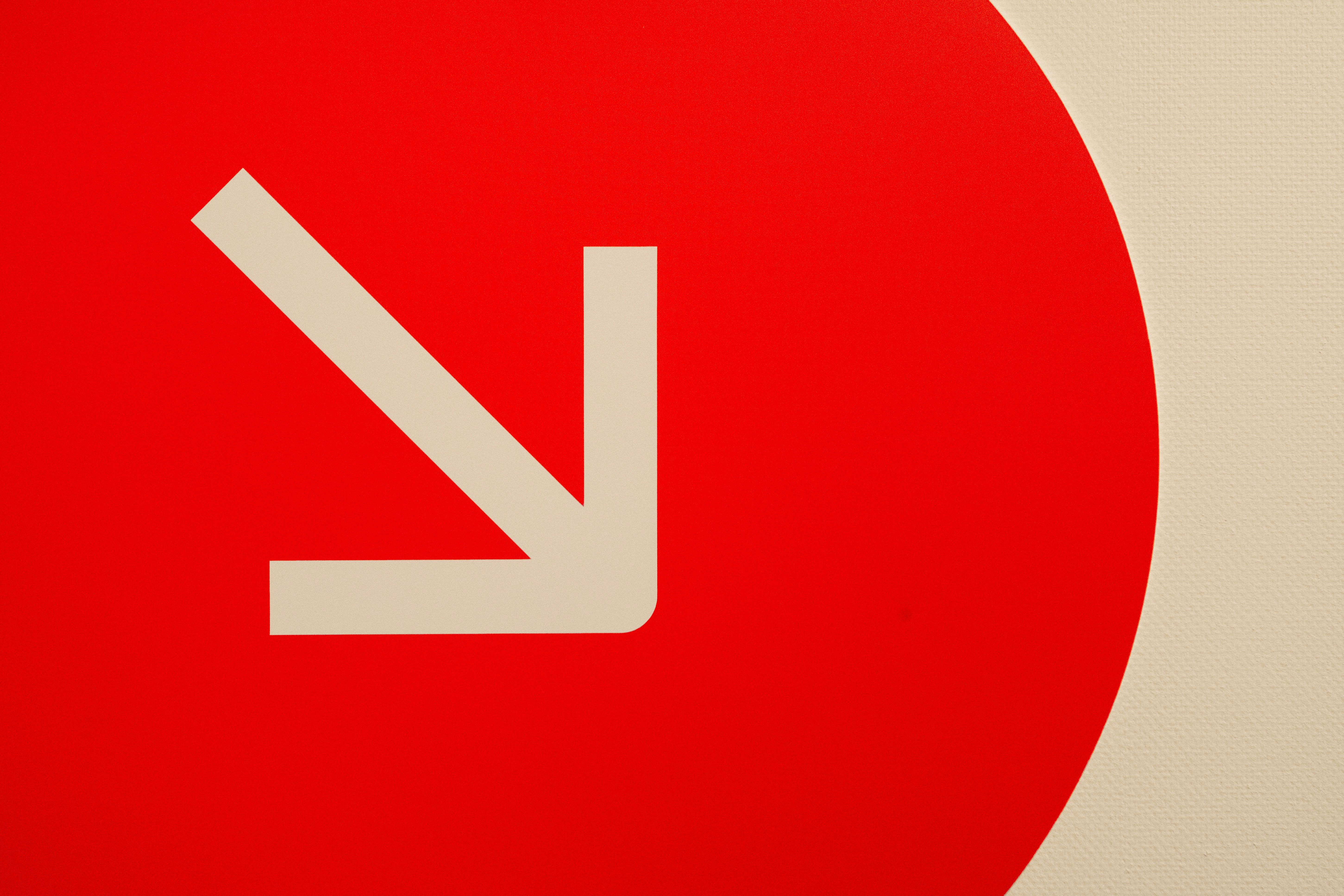 Arrow Down on Red Background
