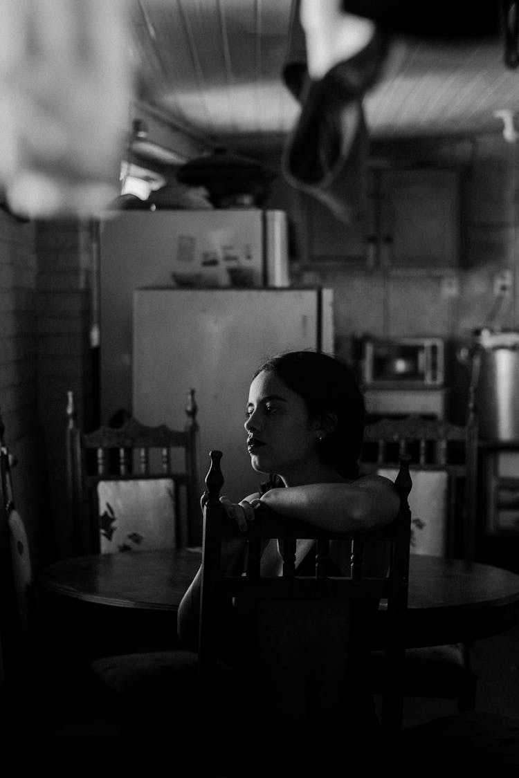  Woman Sitting At The Table In The Kitchen 