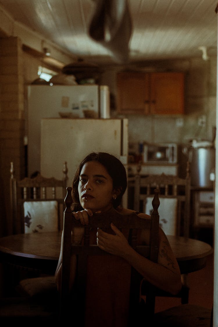  Woman Sitting At The Table In The Kitchen 