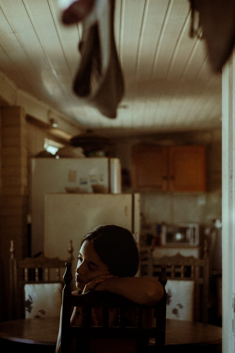  Woman Sitting At The Table In The Kitchen 