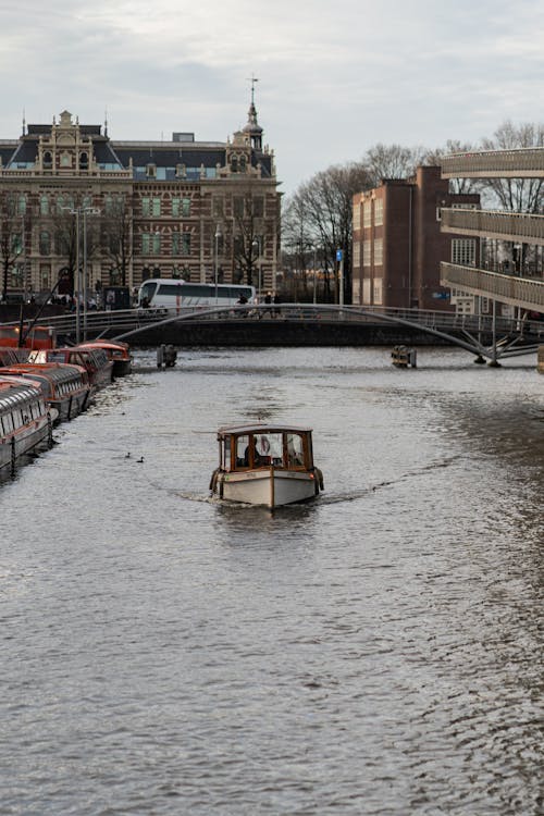 A Boat in the Canal in Amsterdam, the Netherlands