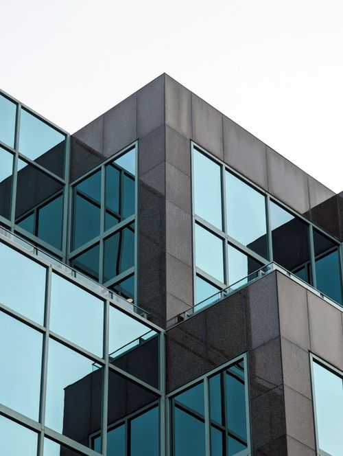 Free Elegant modern office building exterior with mirrored glass windows, showcasing minimalistic architectural design in Halifax. Stock Photo